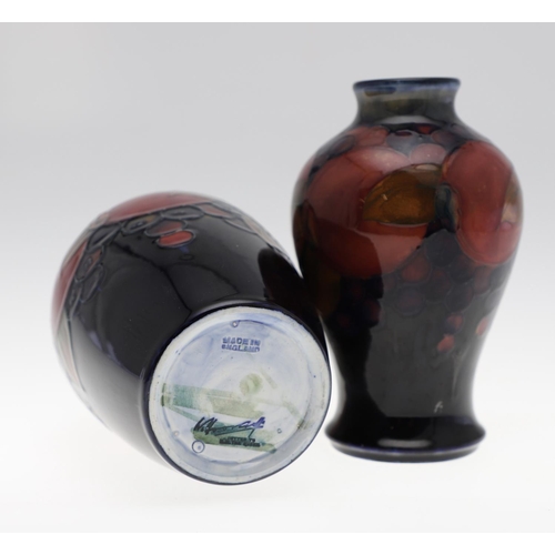 727 - TWO ANTIQUE MOORCROFT VASES - POMEGRANATE. Including a baluster shaped vase, painted in the Pomegran... 