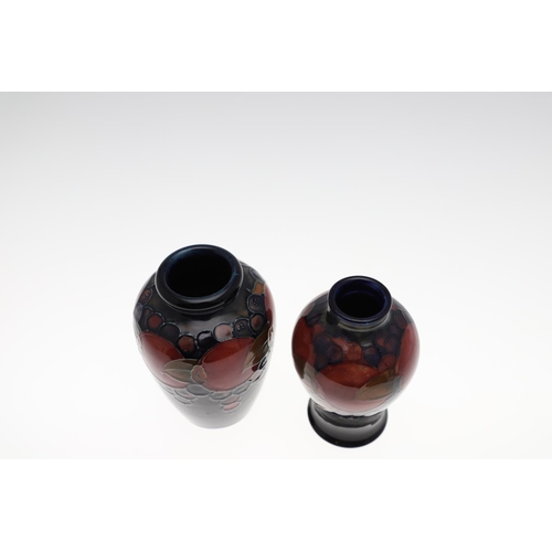 727 - TWO ANTIQUE MOORCROFT VASES - POMEGRANATE. Including a baluster shaped vase, painted in the Pomegran... 