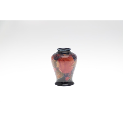 728 - MINIATURE ANTIQUE MOORCROFT VASES. Three various miniature vases, each painted in the Pomegranate de... 