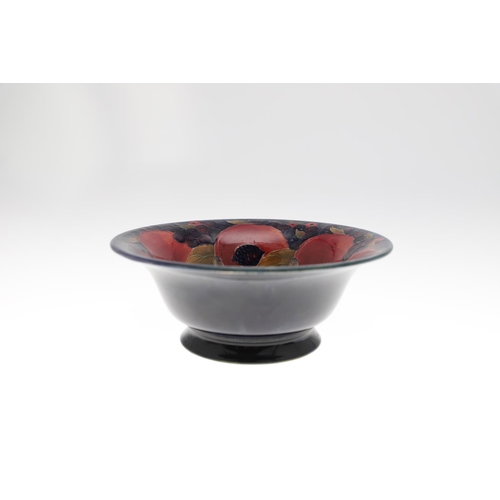 730 - THREE ANTIQUE MOORCROFT LARGE BOWLS - POMEGRANATE. Including a large pedestal bowl painted to the in... 