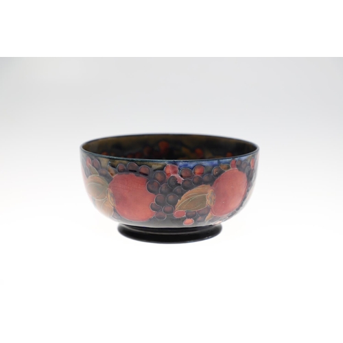 730 - THREE ANTIQUE MOORCROFT LARGE BOWLS - POMEGRANATE. Including a large pedestal bowl painted to the in... 