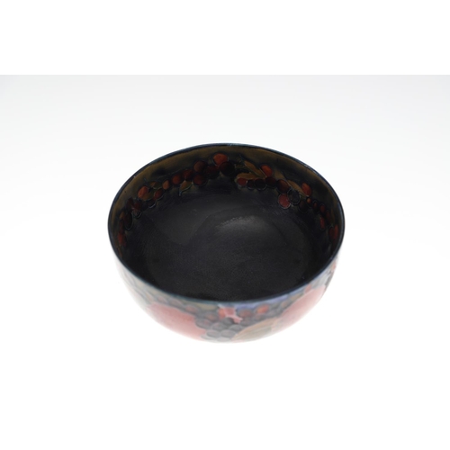 730 - THREE ANTIQUE MOORCROFT LARGE BOWLS - POMEGRANATE. Including a large pedestal bowl painted to the in... 