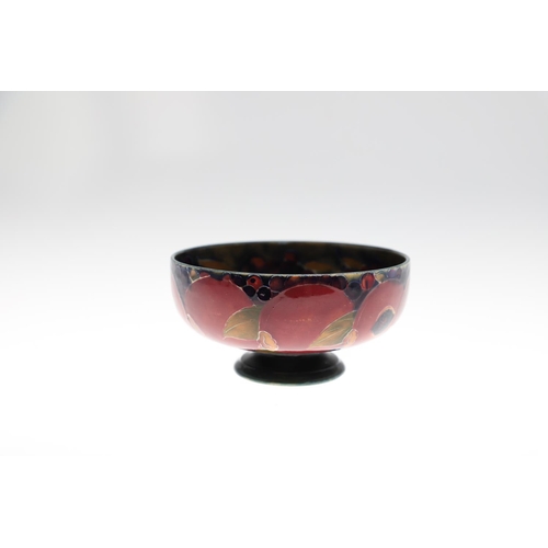 730 - THREE ANTIQUE MOORCROFT LARGE BOWLS - POMEGRANATE. Including a large pedestal bowl painted to the in... 