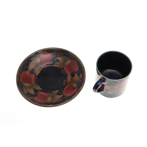 735 - ANTIQUE MOORCROFT ITEMS - POMEGRANATE. A mixed lot including a small slender vase (8.5cms high), a c... 