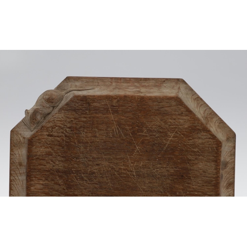 743 - ROBERT THOMPSON OF KILBURN - MOUSEMAN CHEESE BOARD. An oak octagonal shaped cheese board, with carve... 