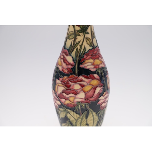 747 - LIMITED EDITION MOORCROFT VASE - CENTREIFOLIA. A slender vase painted with flowers and foliage in th... 