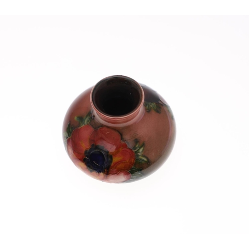 761 - MOORCROFT FLAMBE VASE & LIDDED BOX. A small squat vase painted in the Anemone design with a flambe g... 