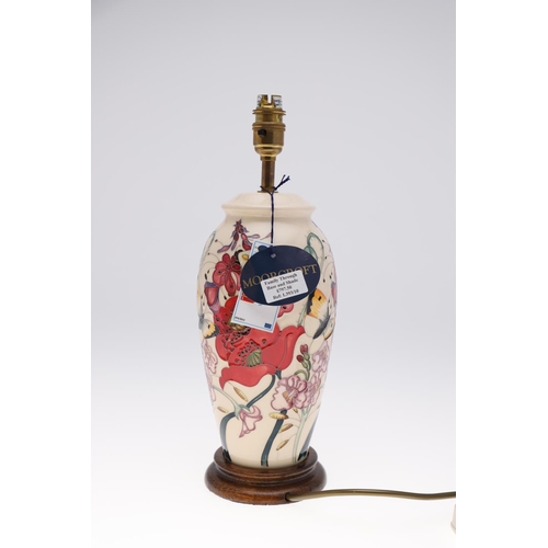 765 - MOORCROFT LAMP & SHADE - FAMILY THROUGH FLOWERS. A large lamp painted with flowers and insects, moun... 