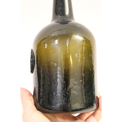 779 - 18THC GLASS SEAL BOTTLE - 1785. The olive green bottle with a tapering neck, string rim and cylindri... 