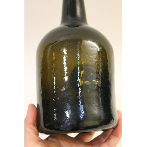 779 - 18THC GLASS SEAL BOTTLE - 1785. The olive green bottle with a tapering neck, string rim and cylindri... 