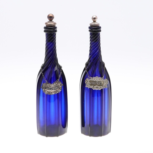 782 - PAIR OF BLUE GLASS DECANTERS & WINE LABELS INCLUDING VICTORIAN SILVER BRANDY LABEL. A pair of blue g... 