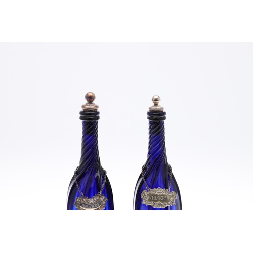 782 - PAIR OF BLUE GLASS DECANTERS & WINE LABELS INCLUDING VICTORIAN SILVER BRANDY LABEL. A pair of blue g... 