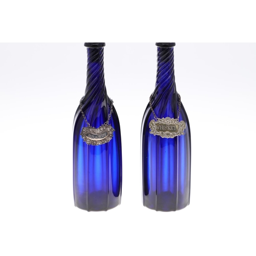 782 - PAIR OF BLUE GLASS DECANTERS & WINE LABELS INCLUDING VICTORIAN SILVER BRANDY LABEL. A pair of blue g... 