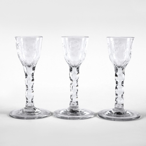 785 - THREE 19THC WINE GLASSES. 19thc in the 18thc style, with a small ogee shaped bowl etched with flower... 