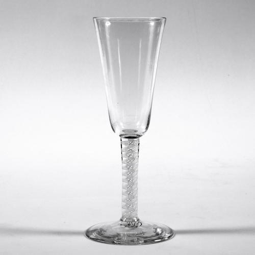 787 - GEORGIAN AIR TWIST WINE GLASS. The glass with an elongated bowl, with an air twist glass stem around... 