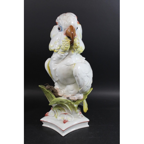 790 - LARGE MEISSEN COCKATOO. 20thc, an unusually large model of a Cockatoo perched amongst foliage, and o... 