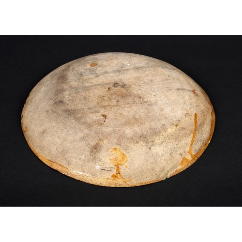 794 - ENGLISH SLIPWARE DISH. Probably 18thc, the deep dish with trails of black slip on an ochre glazed gr... 