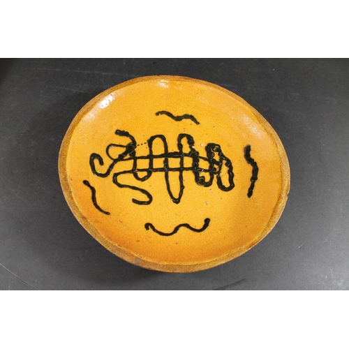 794 - ENGLISH SLIPWARE DISH. Probably 18thc, the deep dish with trails of black slip on an ochre glazed gr... 