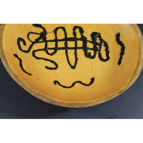 794 - ENGLISH SLIPWARE DISH. Probably 18thc, the deep dish with trails of black slip on an ochre glazed gr... 