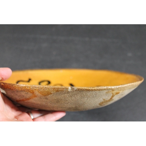 794 - ENGLISH SLIPWARE DISH. Probably 18thc, the deep dish with trails of black slip on an ochre glazed gr... 