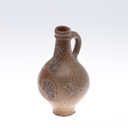 798 - A GERMAN STONEWARE BELLAMINE JUG. Of traditional form with a bearded mask to the neck and foliate me... 