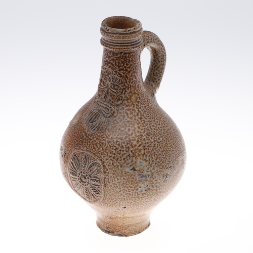 798 - A GERMAN STONEWARE BELLAMINE JUG. Of traditional form with a bearded mask to the neck and foliate me... 