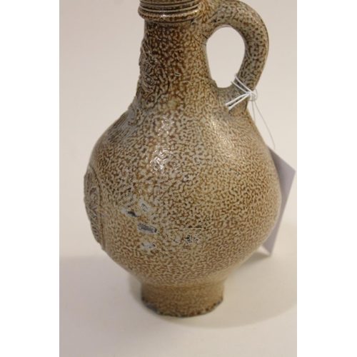 798 - A GERMAN STONEWARE BELLAMINE JUG. Of traditional form with a bearded mask to the neck and foliate me... 