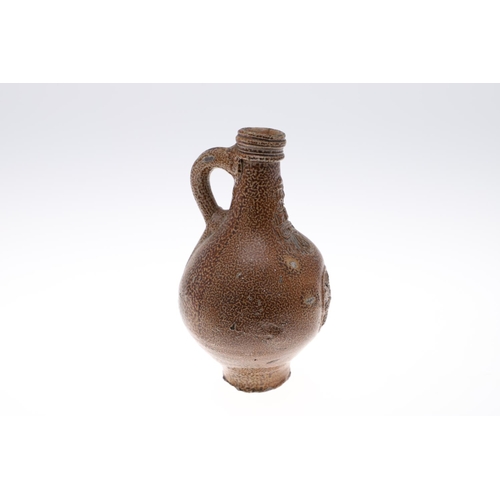 798 - A GERMAN STONEWARE BELLAMINE JUG. Of traditional form with a bearded mask to the neck and foliate me... 