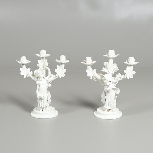 806 - PAIR OF 19THC MOORE BROS PORCELAIN CANDLESBRA. A pair of figural triple branch candelabra, each mode... 