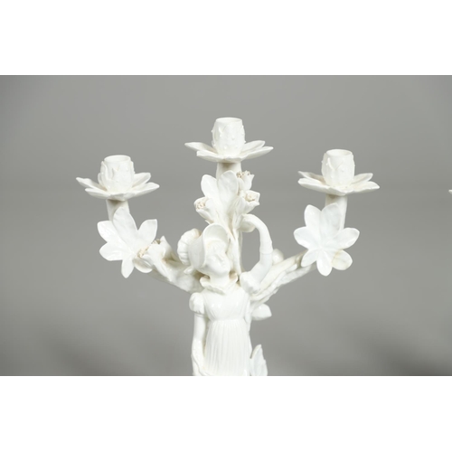 806 - PAIR OF 19THC MOORE BROS PORCELAIN CANDLESBRA. A pair of figural triple branch candelabra, each mode... 