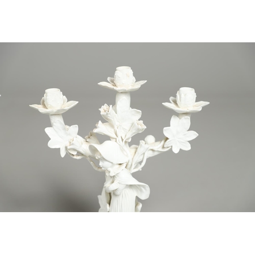 806 - PAIR OF 19THC MOORE BROS PORCELAIN CANDLESBRA. A pair of figural triple branch candelabra, each mode... 