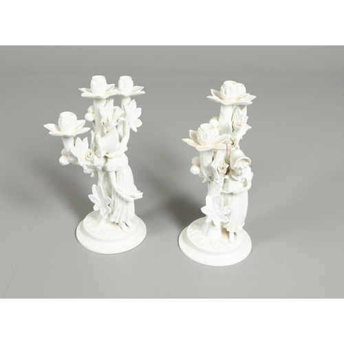 806 - PAIR OF 19THC MOORE BROS PORCELAIN CANDLESBRA. A pair of figural triple branch candelabra, each mode... 