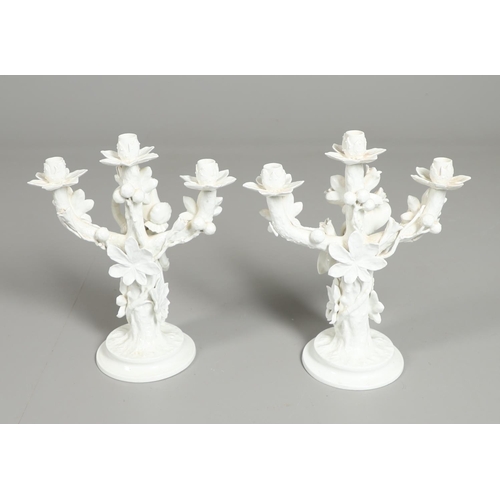 806 - PAIR OF 19THC MOORE BROS PORCELAIN CANDLESBRA. A pair of figural triple branch candelabra, each mode... 