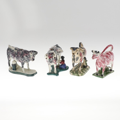 810 - 19THC COW CREAMERS. Four various Cow Creamers, each with sponge decoration and milkmaid to the base.... 