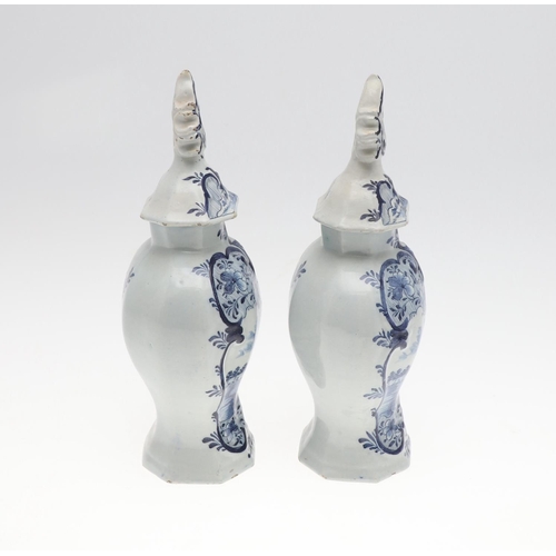 821 - PAIR OF ANTIQUE DELFT LIDDED VASES. 19th, the vases painted with two figures fishing within a landsc... 