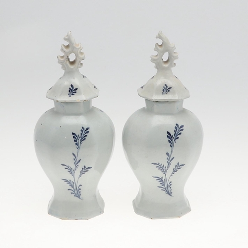 821 - PAIR OF ANTIQUE DELFT LIDDED VASES. 19th, the vases painted with two figures fishing within a landsc... 