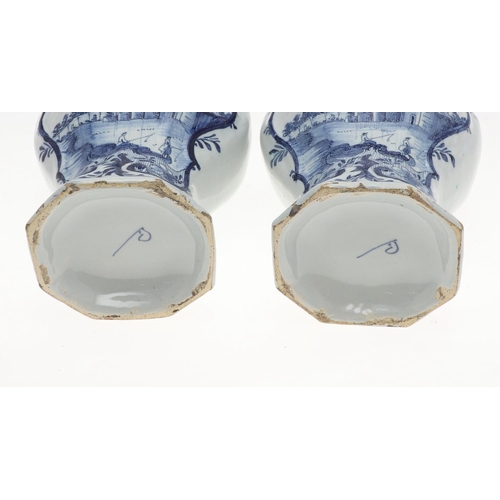 821 - PAIR OF ANTIQUE DELFT LIDDED VASES. 19th, the vases painted with two figures fishing within a landsc... 