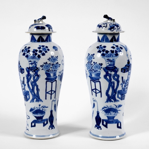 833 - PAIR OF CHINESE 19THC BLUE & WHITE LIDDED VASES. A pair of 19thc baluster shaped lidded vases, paint... 