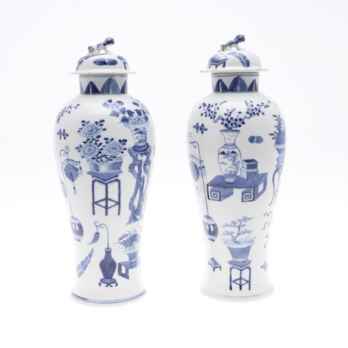 833 - PAIR OF CHINESE 19THC BLUE & WHITE LIDDED VASES. A pair of 19thc baluster shaped lidded vases, paint... 