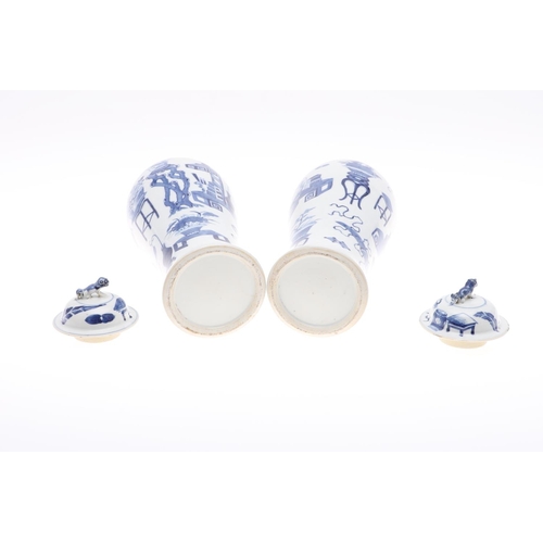 833 - PAIR OF CHINESE 19THC BLUE & WHITE LIDDED VASES. A pair of 19thc baluster shaped lidded vases, paint... 