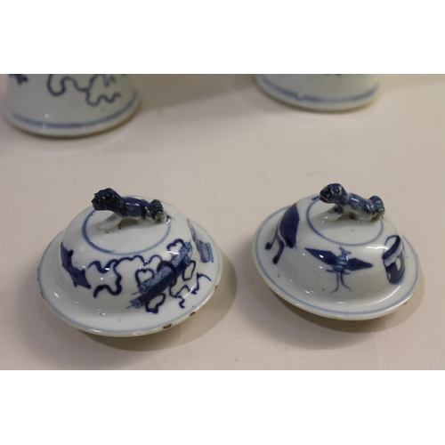 833 - PAIR OF CHINESE 19THC BLUE & WHITE LIDDED VASES. A pair of 19thc baluster shaped lidded vases, paint... 