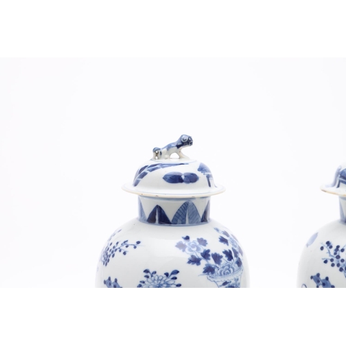 833 - PAIR OF CHINESE 19THC BLUE & WHITE LIDDED VASES. A pair of 19thc baluster shaped lidded vases, paint... 