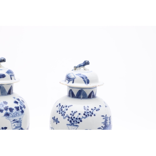 833 - PAIR OF CHINESE 19THC BLUE & WHITE LIDDED VASES. A pair of 19thc baluster shaped lidded vases, paint... 