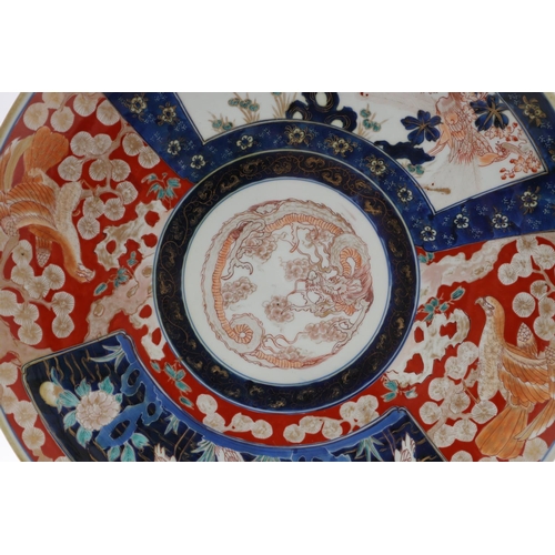 835 - LARGE JAPANESE IMARI CHARGER. Meiji period, the large charger painted in the centre with a Dragon, w... 