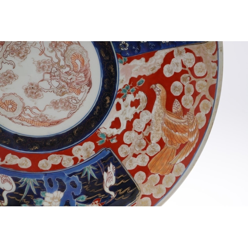 835 - LARGE JAPANESE IMARI CHARGER. Meiji period, the large charger painted in the centre with a Dragon, w... 