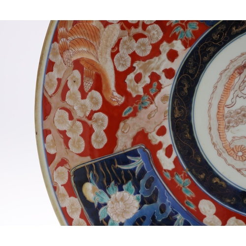 835 - LARGE JAPANESE IMARI CHARGER. Meiji period, the large charger painted in the centre with a Dragon, w... 