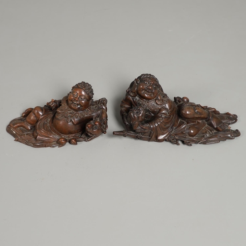 844 - TWO 19THC CHINESE CARVED BUDDHA GROUPS. Two well carved 19thc large carved wooden groups of reclinin... 