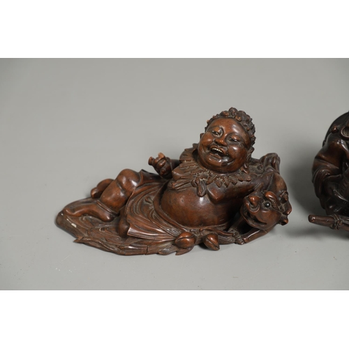 844 - TWO 19THC CHINESE CARVED BUDDHA GROUPS. Two well carved 19thc large carved wooden groups of reclinin... 