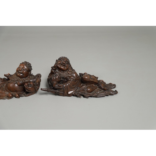 844 - TWO 19THC CHINESE CARVED BUDDHA GROUPS. Two well carved 19thc large carved wooden groups of reclinin... 