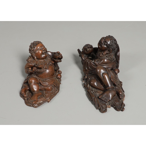 844 - TWO 19THC CHINESE CARVED BUDDHA GROUPS. Two well carved 19thc large carved wooden groups of reclinin... 